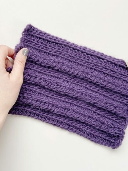 crochet braid stitch swatch in purple yarn with furls crochet hook