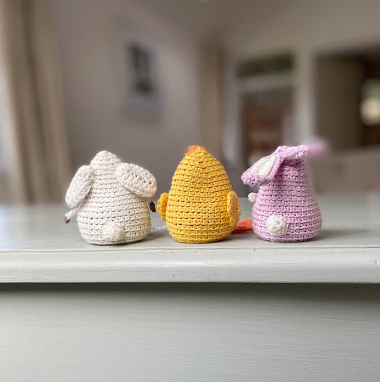 back view of amigurumi crochet toys bunny, chick and lamb