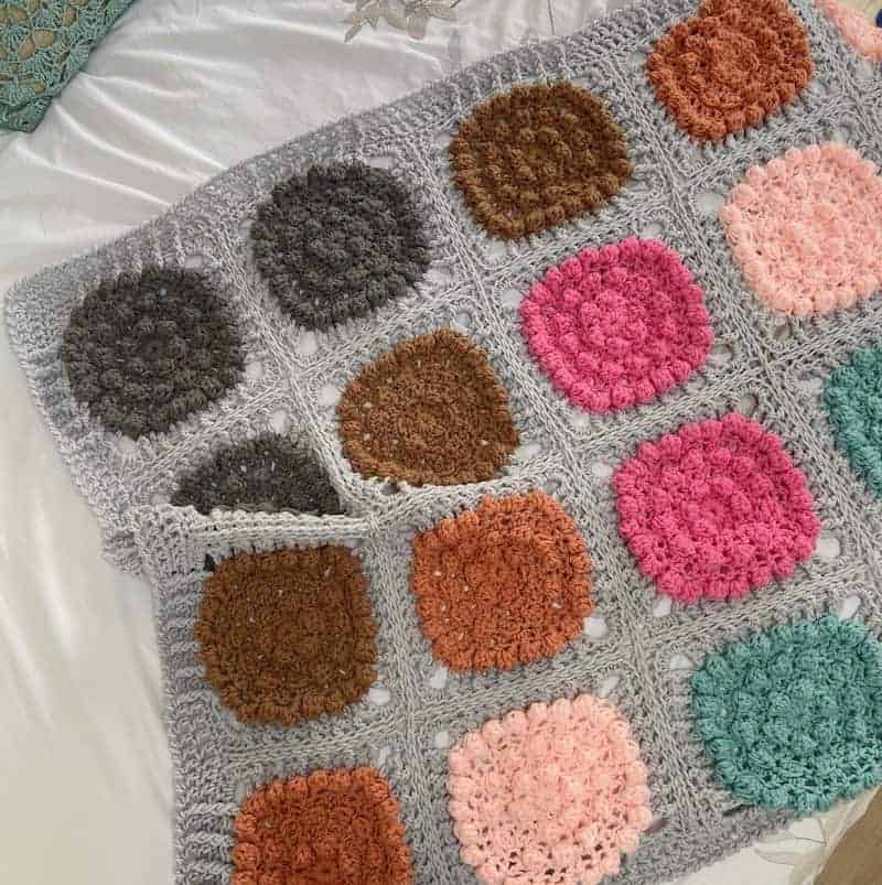 Alexa crochet blanket laying on a bed