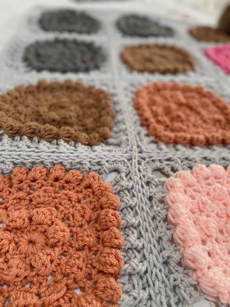 Close up of a chunky crochet blanket with bobble stitches