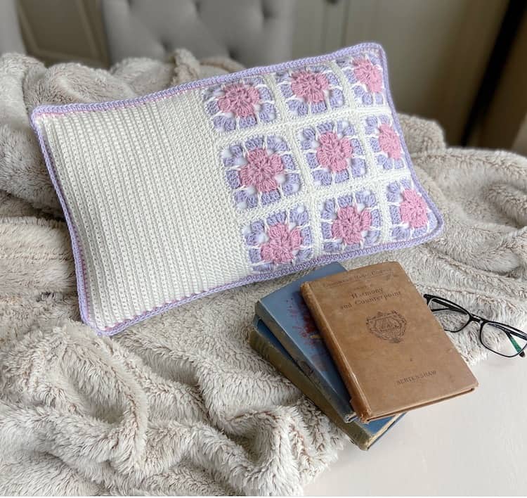 9 crochet floral granny square motifs on cushion cover in white, pink and lilac 