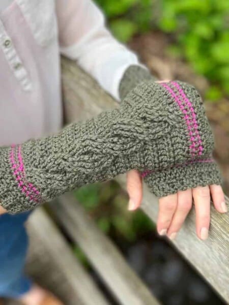 Cable crochet wrist warmer pattern in green.