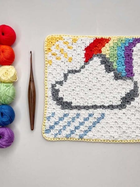 c2c square pattern with rainbow, cloud, sun and showers with hook and yarn.