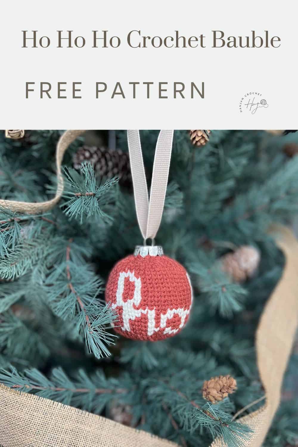 A crocheted Christmas bauble with "Ho Ho Ho" text hangs on a ribbon from a Christmas tree. A banner above reads "Ho Ho Ho Crochet Bauble Decoration Free Pattern.