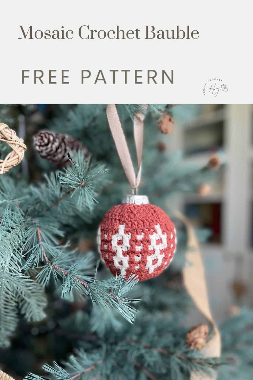 A red and white overlay mosaic crochet bauble hangs from a branch of a Christmas tree. The image promotes a free pattern for making the bauble.