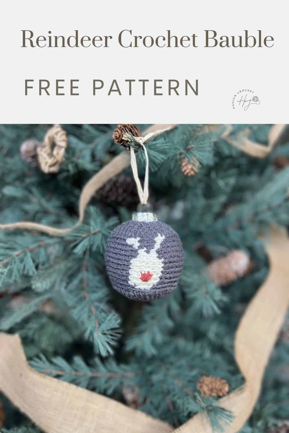 A crocheted bauble with a reindeer design hanging on a Christmas tree. The text reads, "Reindeer Crochet Bauble FREE PATTERN.