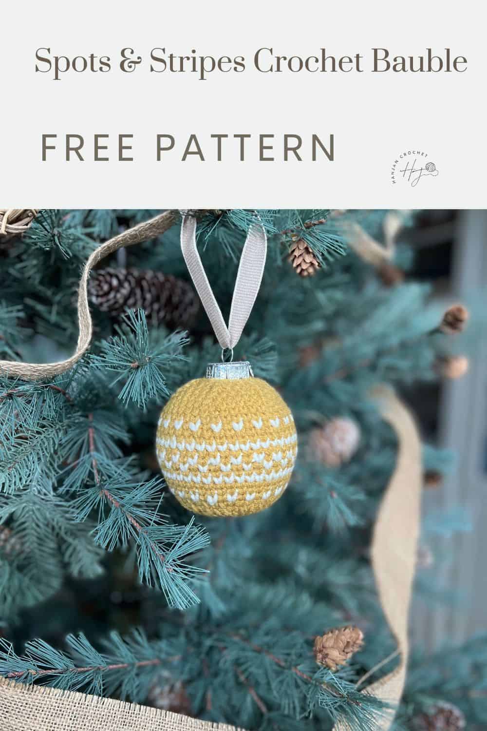 Close-up of a Christmas tree adorned with a yellow and white crochet bauble, hanging from a white ribbon. Text on the image reads, "Spots & Stripes Fair Isle Crochet Bauble FREE PATTERN.