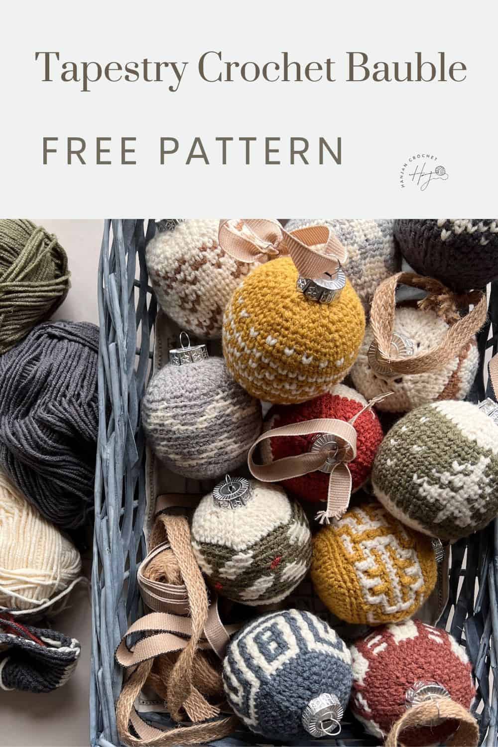 A basket contains various handmade crochet baubles in different colors and patterns, accompanied by balls of yarn. The text above reads "Tapestry Crochet Bauble Free Pattern.