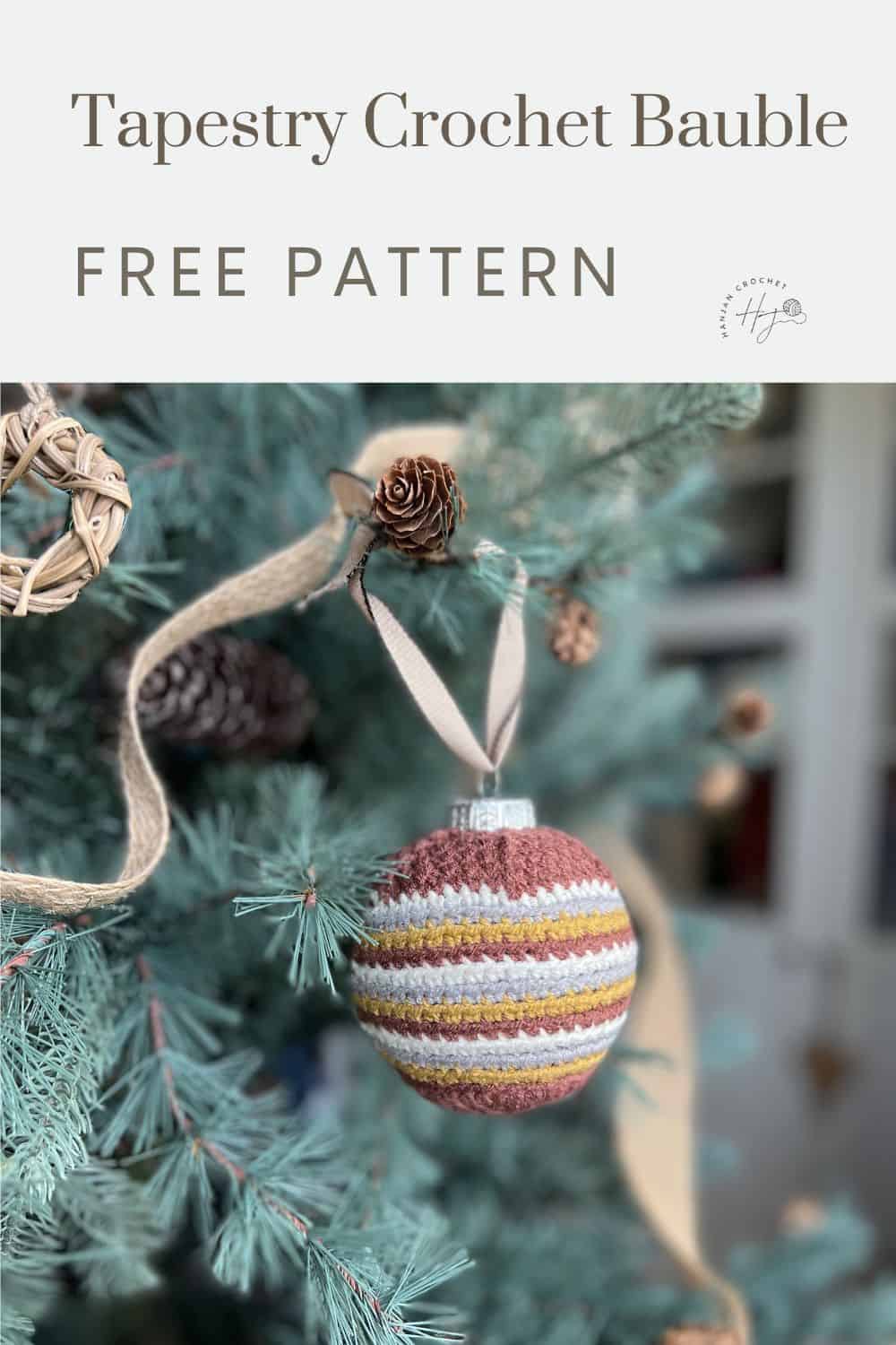 A striped crochet bauble hanging on a pine tree with a ribbon. Text reads: "Tapestry Stripe Crochet Bauble Free Pattern.