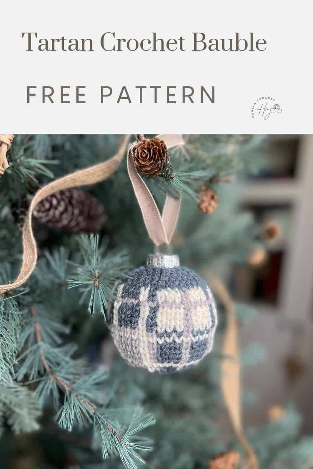 A tartan-patterned crochet bauble hangs on a Christmas tree branch adorned with a brown ribbon and pinecones. The image features the text "Tartan Crochet Bauble Free Pattern.