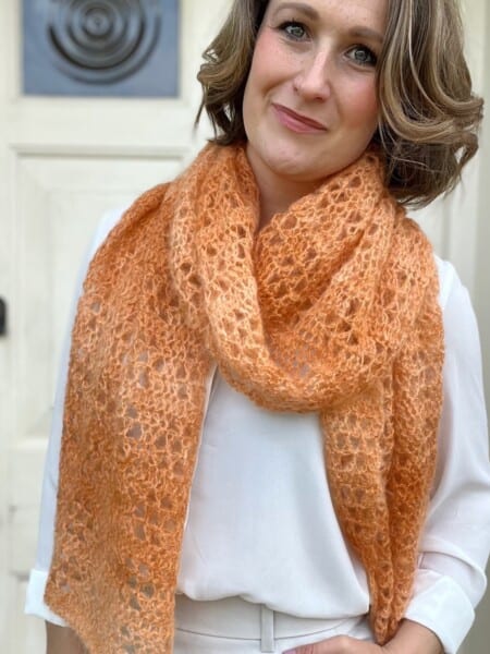 Elegant scarf crochet patten in orange mohair yarn.