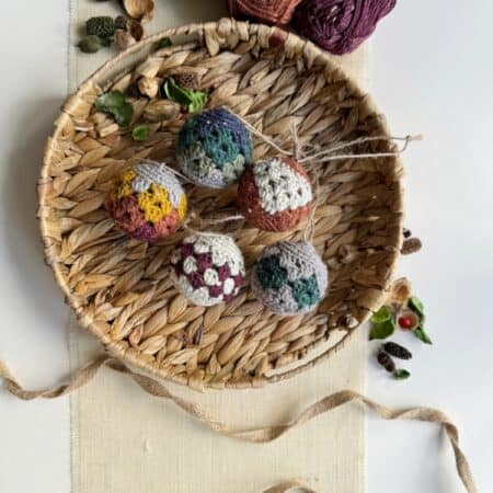 Crocheted balls in a basket on a table.