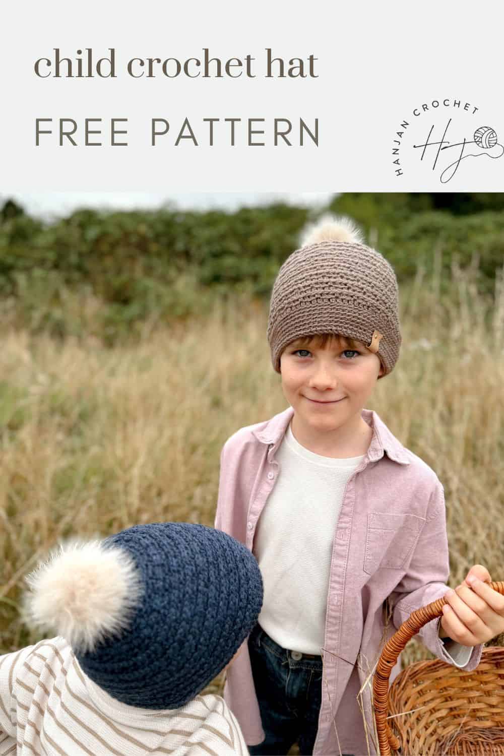 Two children outdoors in a field. One wears a beige crochet hat, holding a basket. The other wears a blue crochet hat with a white pom-pom. Text reads "Child Boys Crochet Hat Free Pattern.